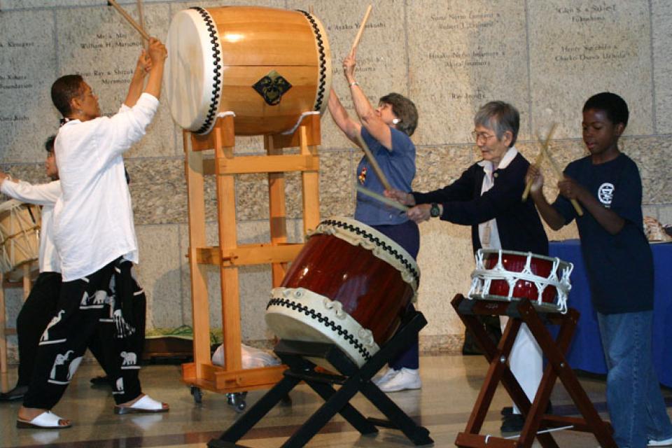 Audience participates by beating on various drums